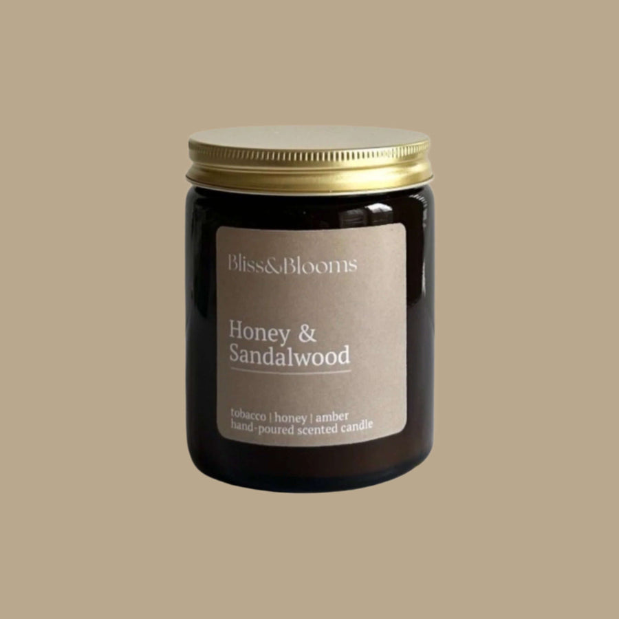 Luxury honey sandalwood scented candle, handcrafted premium soy wax in amber glass jar with gold lid, warm woody fragrance, 35-hour burn time by Bliss & Blooms at brixbailey.com