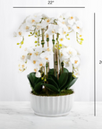 Faux orchid centerpiece in white vase