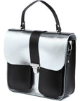 a soft-focus shot of the silver leather bag with its warm chocolate base glowing in gentle light