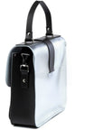 silver leather top handle bag with chocolate calf hair base in a functional side view showing its double front pockets