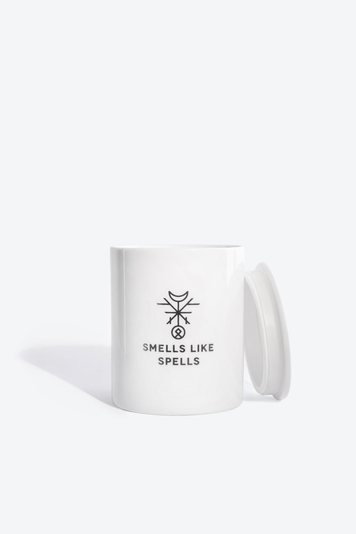 the hermit scented candle glowing softly in a cozy meditation space