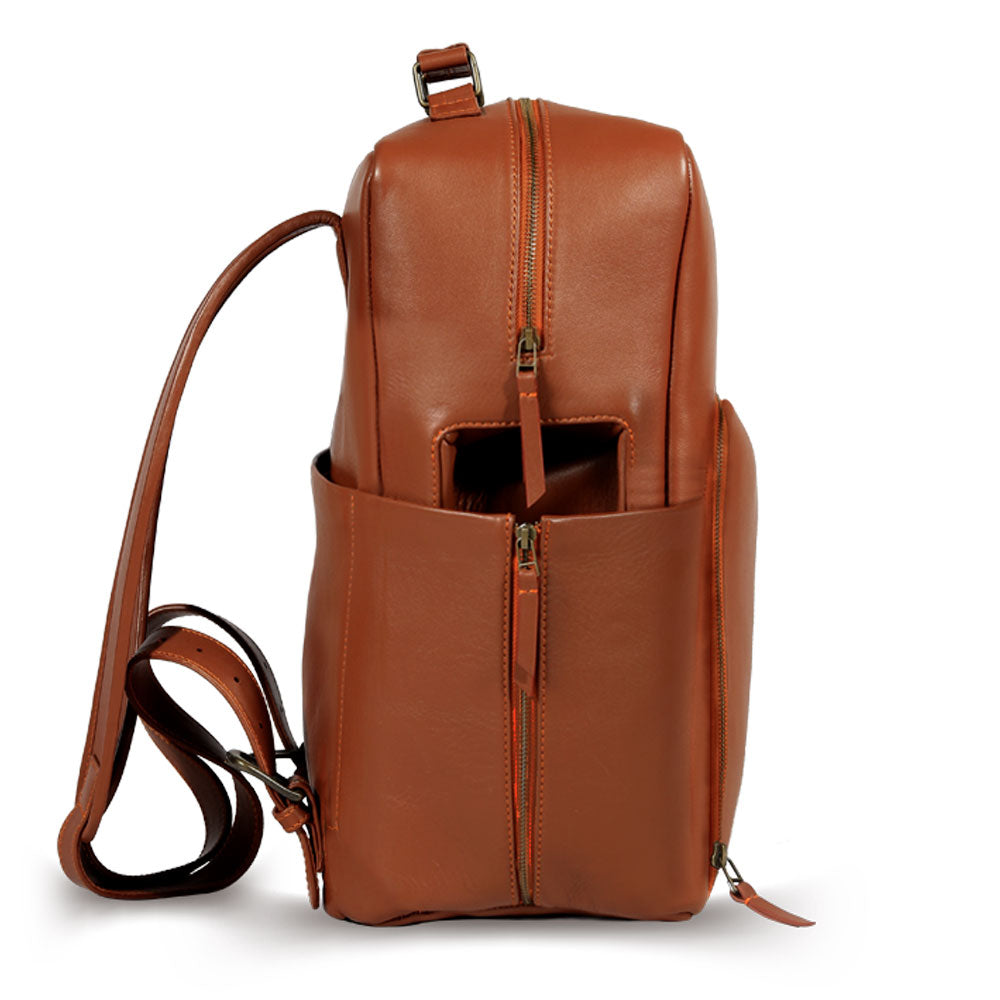 Premium tan leather backpack for travel and adventure, sustainable recycled materials, handcrafted full-grain Nappa leather, antique brass hardware, spacious laptop compartment, durable slow-fashion design by Bethikal at brixbailey.com