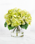 Silk hydrangea centerpiece arrangement in glass vase