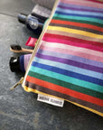 Premium organic cotton rainbow toiletry bag, British woven recycled yarn, waterproof lining, sturdy zip, versatile for baby essentials or travel by Maison Elhoria at brixbailey.com