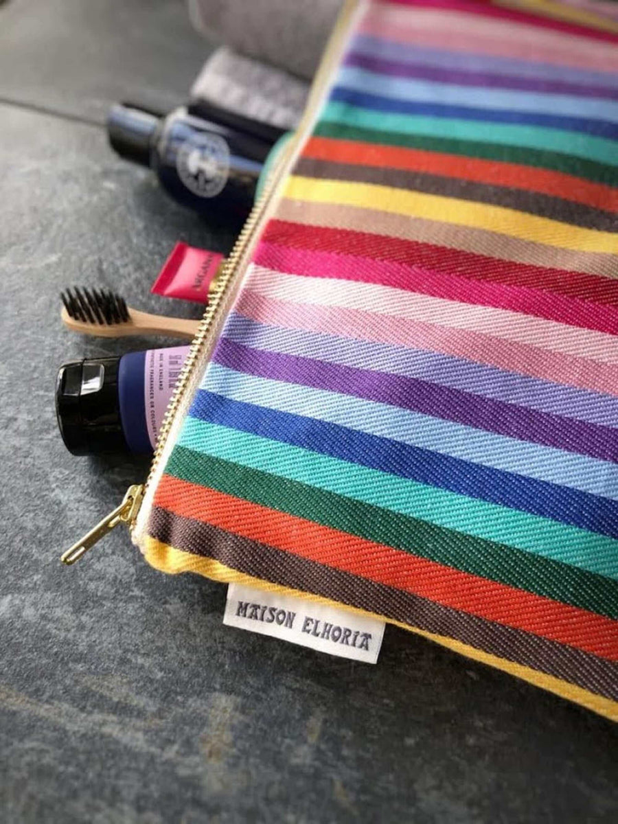 Premium organic cotton rainbow toiletry bag, British woven recycled yarn, waterproof lining, sturdy zip, versatile for baby essentials or travel by Maison Elhoria at brixbailey.com