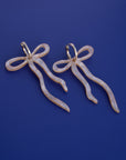 Pearlescent Beige Dangly Bow Hoop Earrings