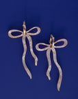 Pearlescent Beige Dangly Bow Hoop Earrings