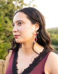 Pearlescent Beige Dangly Bow Hoop Earrings