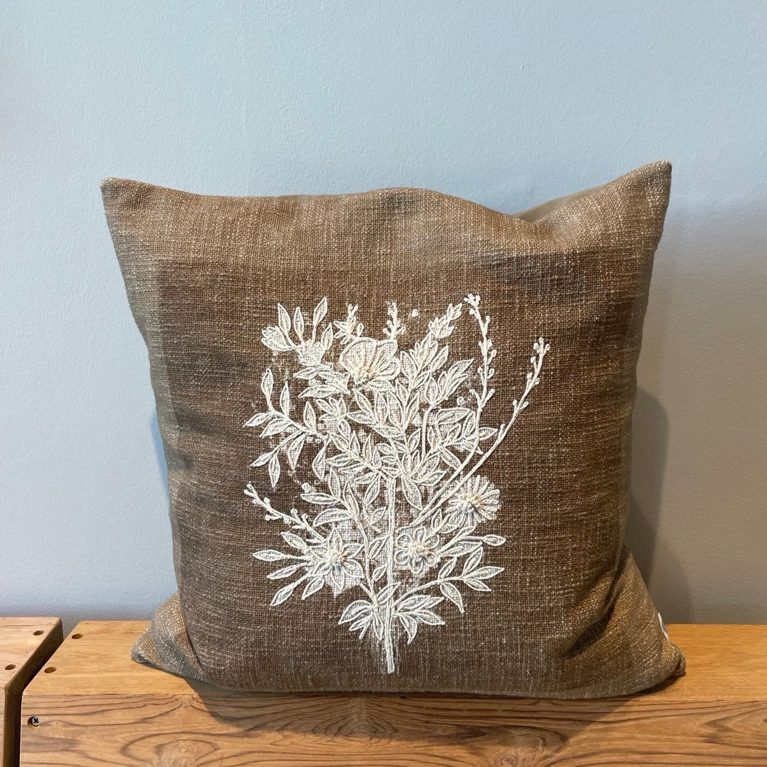 Luxury Ila cushion in olive brown cotton with hand-embroidered floral design, warm and inviting home decor accent by Ella James at brixbailey.com