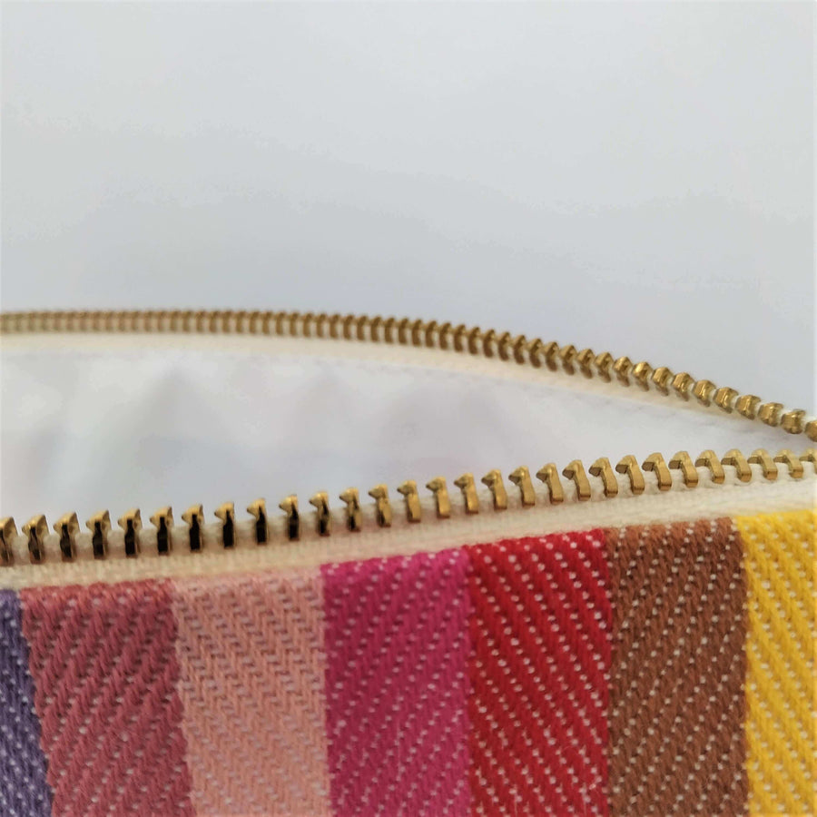 Premium rainbow toiletry bag, luxury British woven organic cotton, waterproof lining, durable zip, versatile for baby essentials or travel by Maison Elhoria at brixbailey.com