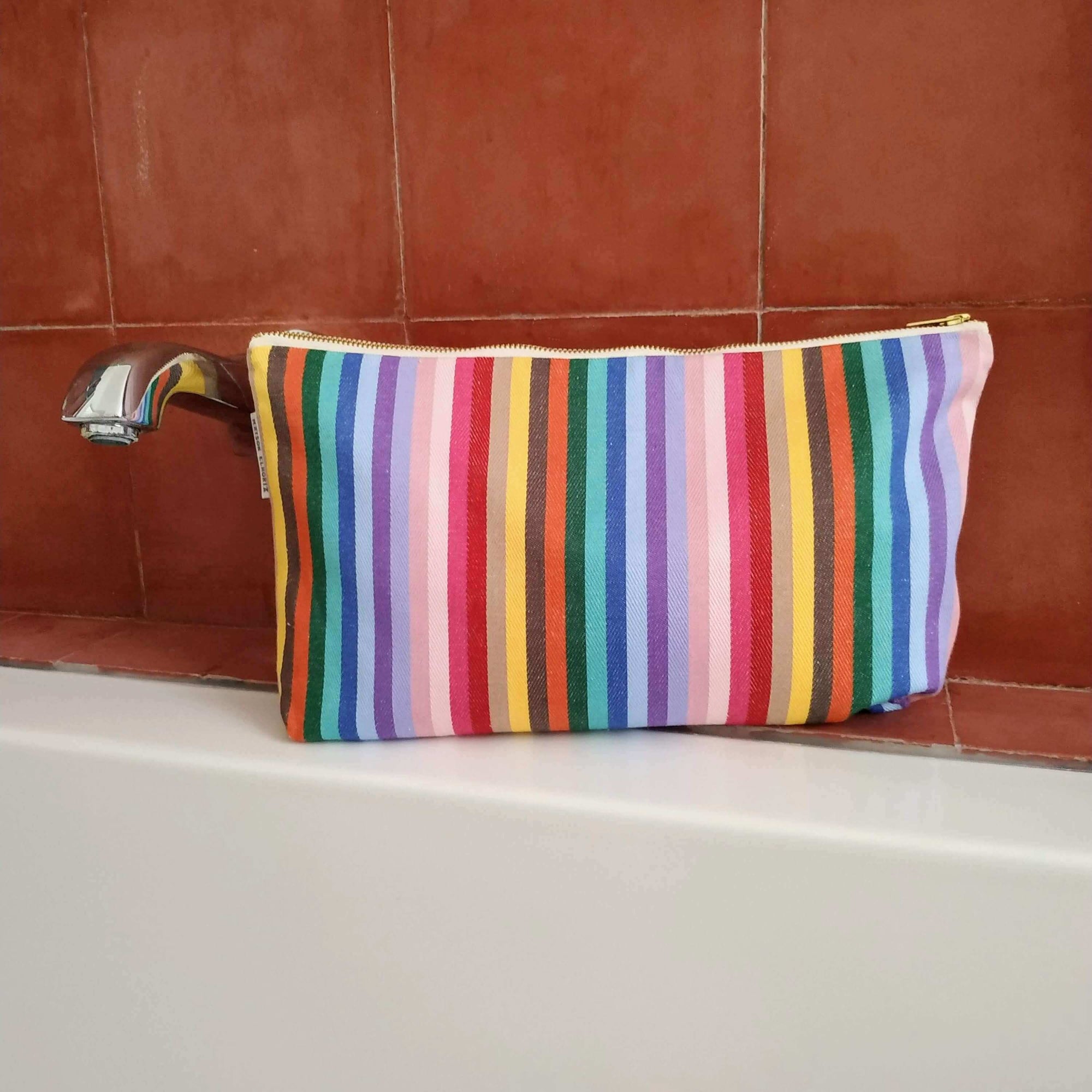 Premium rainbow toiletry bag, luxury British woven organic cotton, waterproof lining, sturdy zip, versatile for baby essentials, washable recycled yarns by Maison Elhoria at brixbailey.com