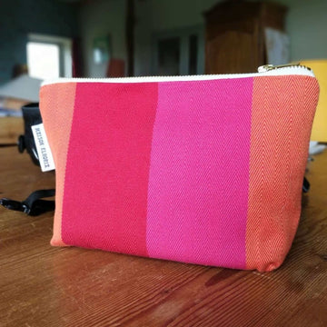 Premium British-made zip toiletry bag, red orange pink, compact 8 inch, organic cotton, waterproof lining, herringbone stripes by Maison Elhoria at brixbailey.com