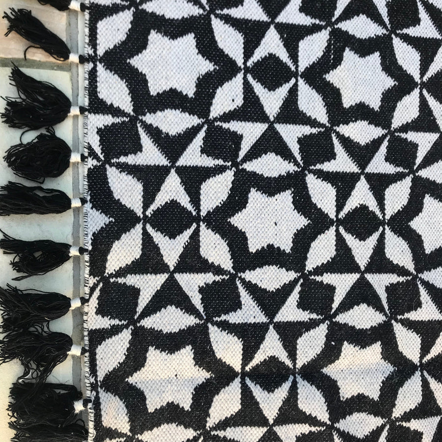 Luxury monochrome flat weave wool rug, handmade in India, stylish geometric design with tassels, best-selling contemporary ethnic decor by Maria Starling Design at brixbailey.com