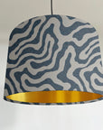 Blue wiggle drum lampshade/ ceiling shade with a metallic brushed gold lining