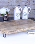 Premium Takli serving chopping board on legs, sustainable mango wood, elegant raised design, multifunctional kitchen centerpiece by Maravi at brixbailey.com