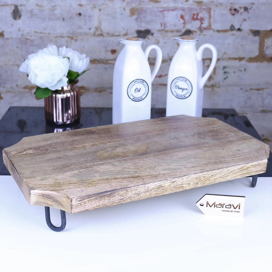 Premium Takli serving chopping board on legs, sustainable mango wood, elegant raised design, multifunctional kitchen centerpiece by Maravi at brixbailey.com