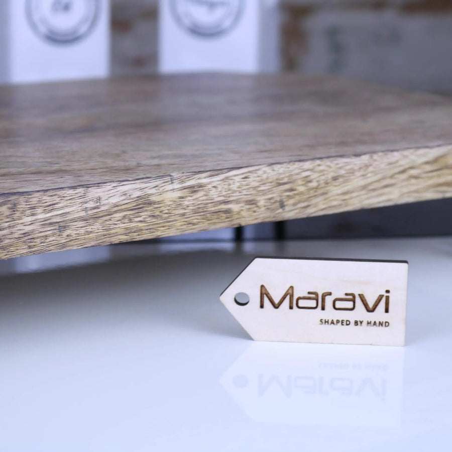 Premium Takli serving chopping board on legs, luxury mango wood charcuterie board with raised metal legs, stylish kitchen accessory by Maravi at brixbailey.com