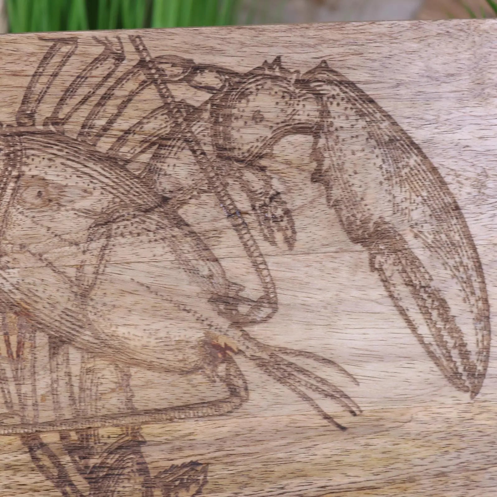 Luxury handcrafted wooden fish serving platter board with intricate lobster or fish engraving, premium mango wood, coastal kitchenware by Maravi at brixbailey.com