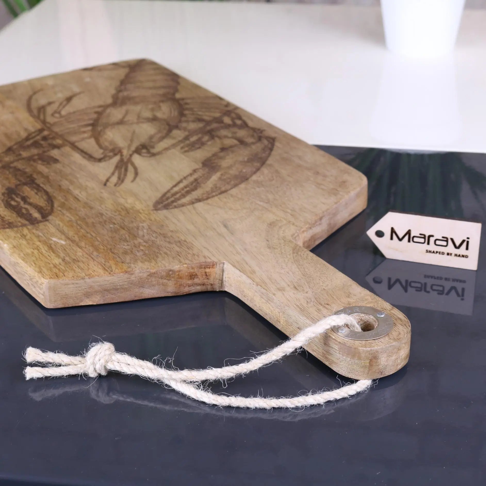 Luxury handcrafted fish serving platter board, premium mango wood with intricate lobster or fish engraving, stylish coastal kitchenware by Maravi at brixbailey.com