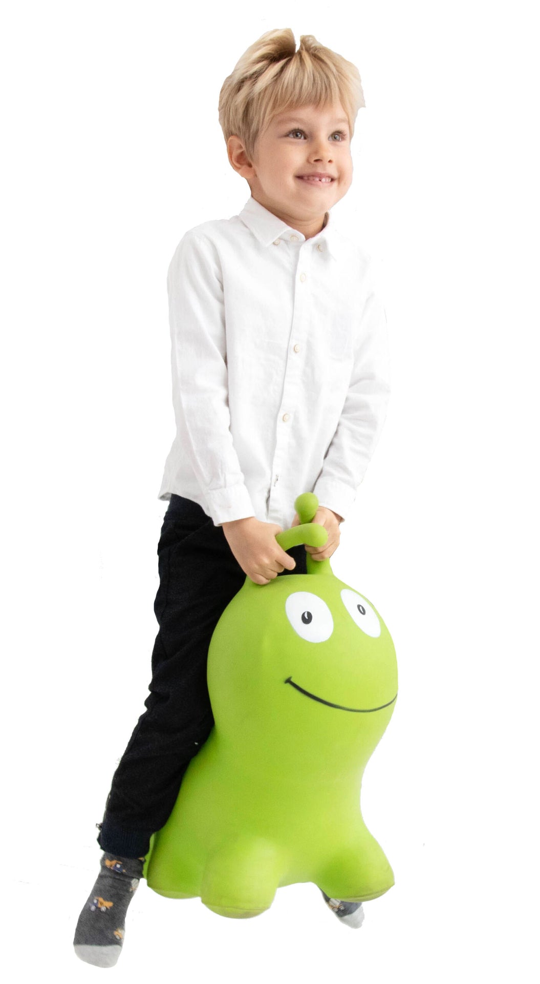 confident toddler jumping high on a bright green wormy hopper toy indoors