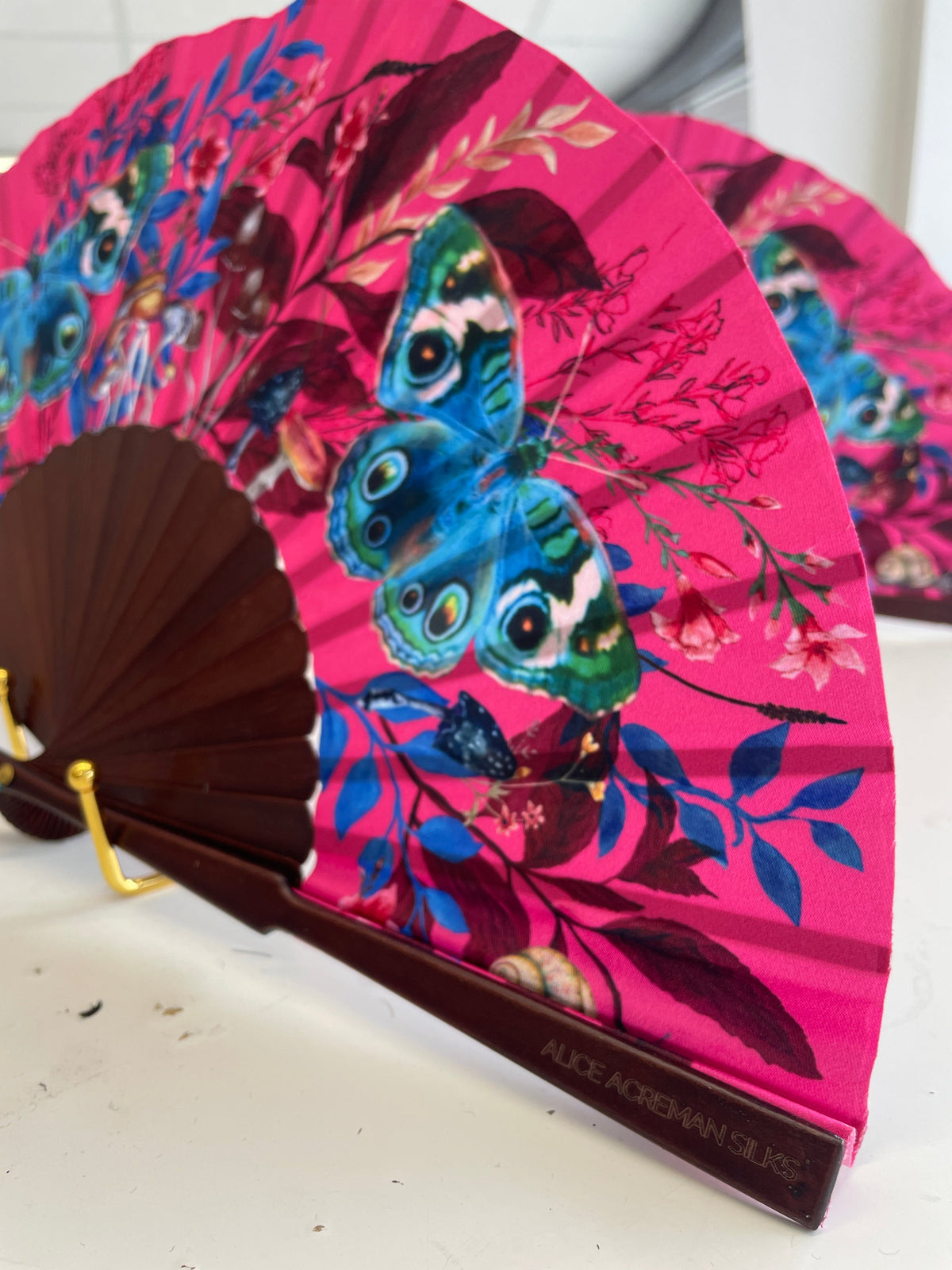 Hot pink 'Fuchsia' silk folding hand fan with butterfly and mushroom painted artwork
