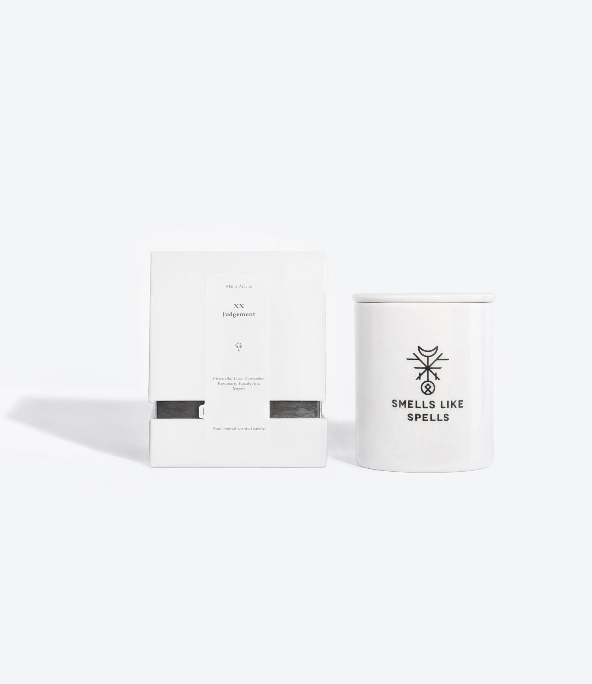 softly lit judgment scented candle in a porcelain jar with a tarot card, glowing with a comforting aura