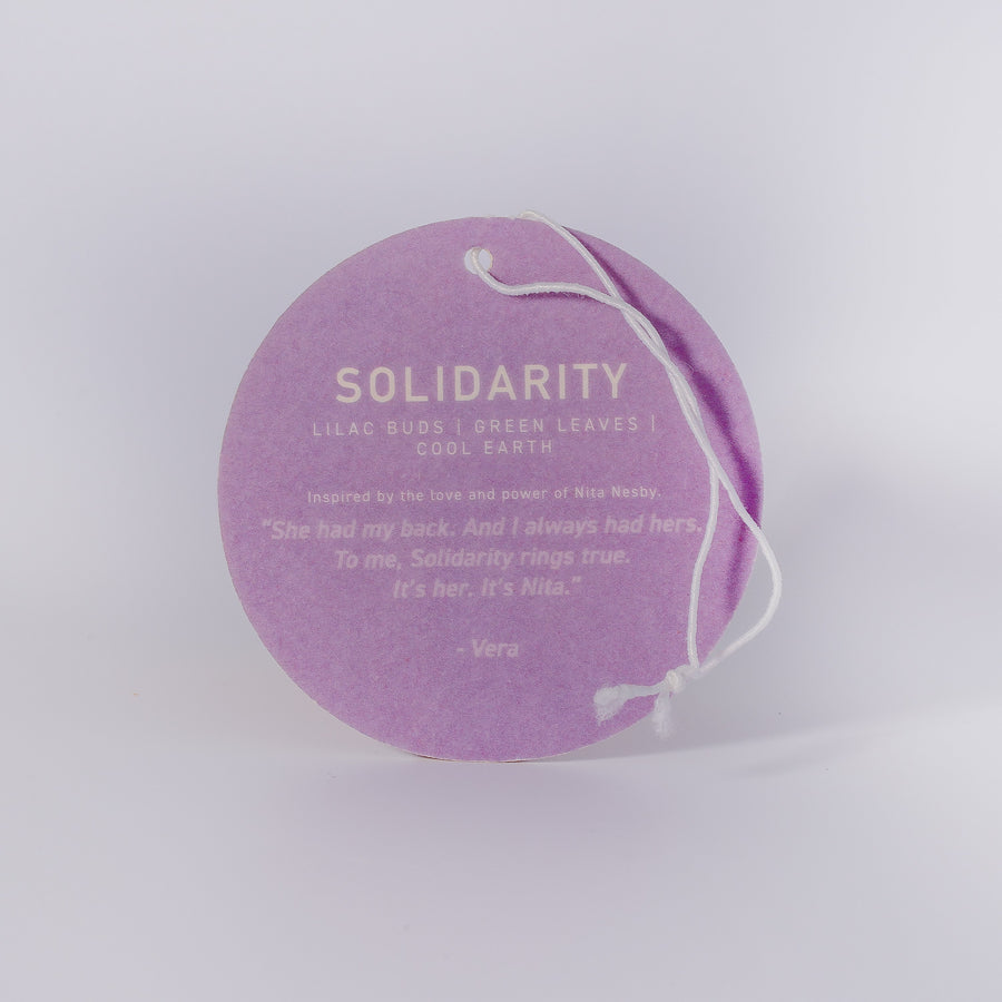 Luxury Solidarity soy candle with lilac buds, green leaves, cool earth, handcrafted in Illinois, premium fragrance, resilience glass vessel by Labyrinth Made Goods at brixbailey.com