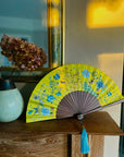 Bright yellow  'Luciferin' silk folding hand fan with flowers and mushroom painted artwork