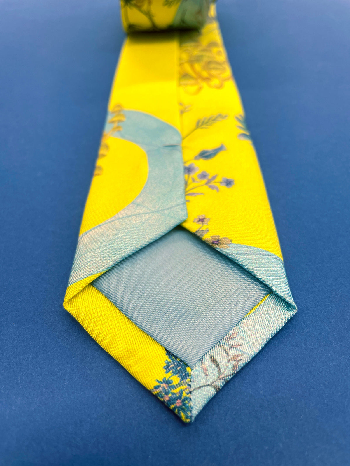 Vibrant yellow and pale blue ‘Luciferin’ floral silk tie