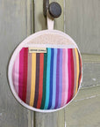 Rainbow pot grab, round oven glove, best-selling heat-resistant handcrafted UK-made kitchen accessory for hot pots by Maison Elhoria at brixbailey.com