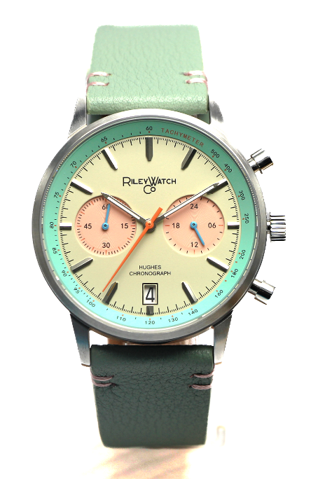 Wristwatch with green strap and multicolor face on a white background Riley Watch Company at Brix +Bailey