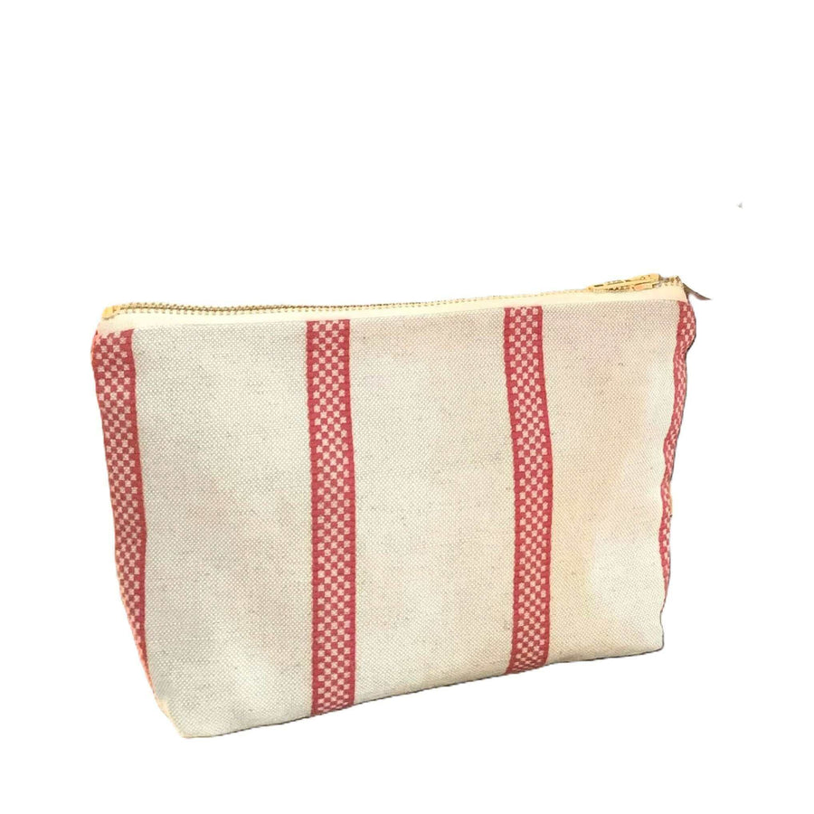Premium linen union toiletry bag with red stripes, compact travel organizer for men and women, stylish vintage design, durable zipper closure by Maison Elhoria at brixbailey.com