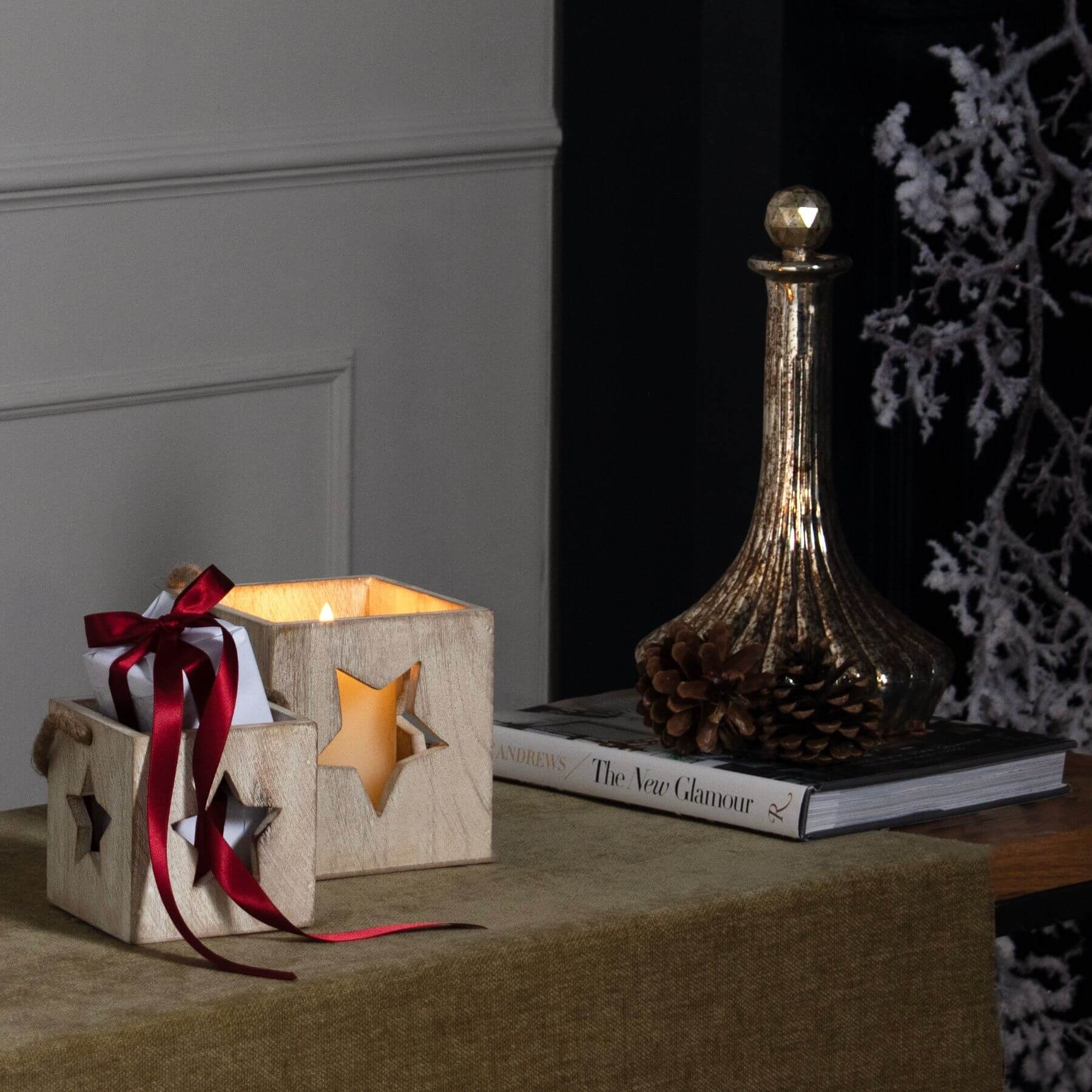 Handcrafted whitewashed wooden star tealight holder with natural grain, casting warm glow patterns for cozy decor. by RoomLondon at brixbailey.com