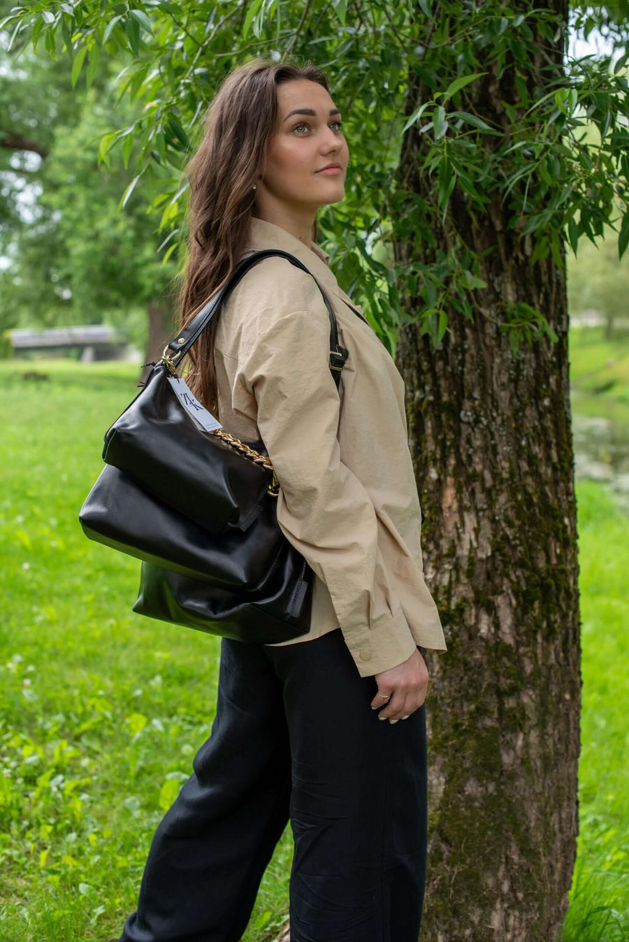 Black Leather Handbag with Metallic Accents, Crossbody
