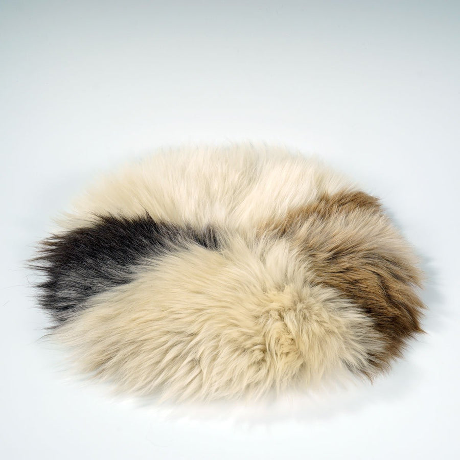 Premium 35cm round sheepskin seat pad, luxury British rare breed natural melange, handcrafted sustainable comfort, soft insulating breathable by Wildash London at brixbailey.com