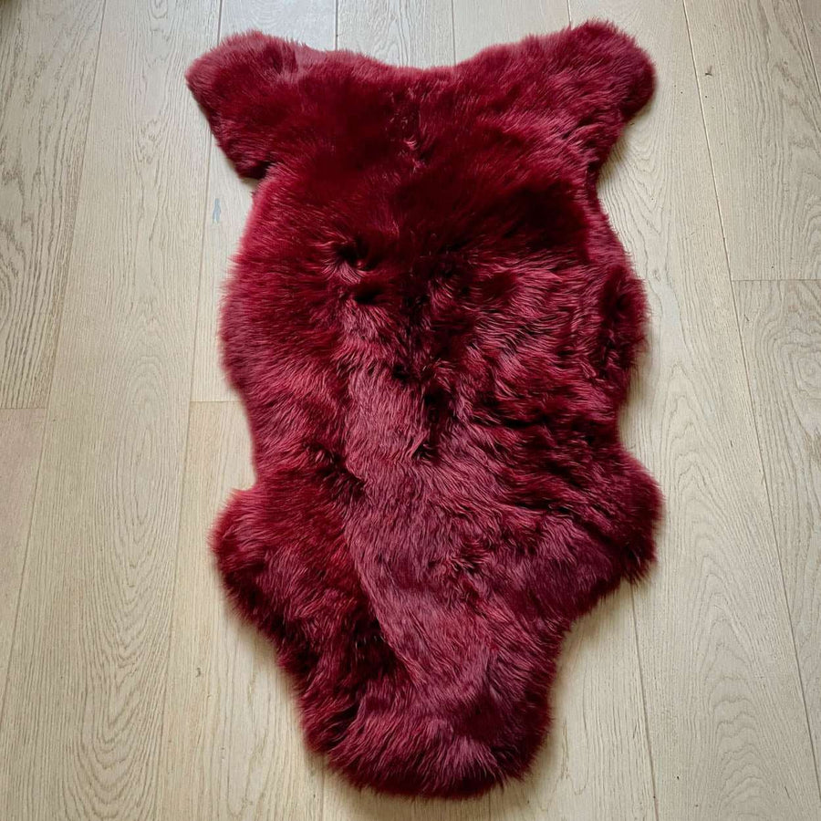 Premium British sheepskin rug, luxury Bordeaux red fleece throw, large ethically sourced organic sheepskin, soft hypoallergenic sustainable fur by Wildash London at brixbailey.com