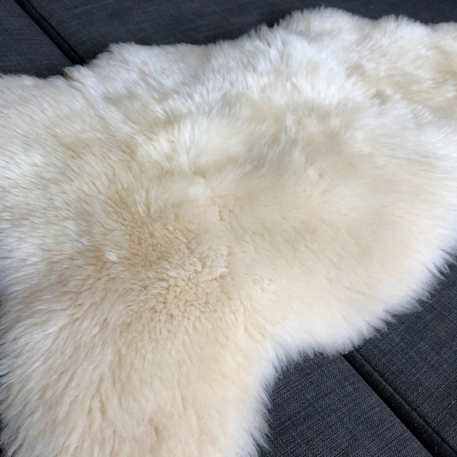 Luxury premium sheepskin rug, full hide with super soft long white fur, natural ivory tone, handcrafted best-selling medium throw by Wildash London at brixbailey.com