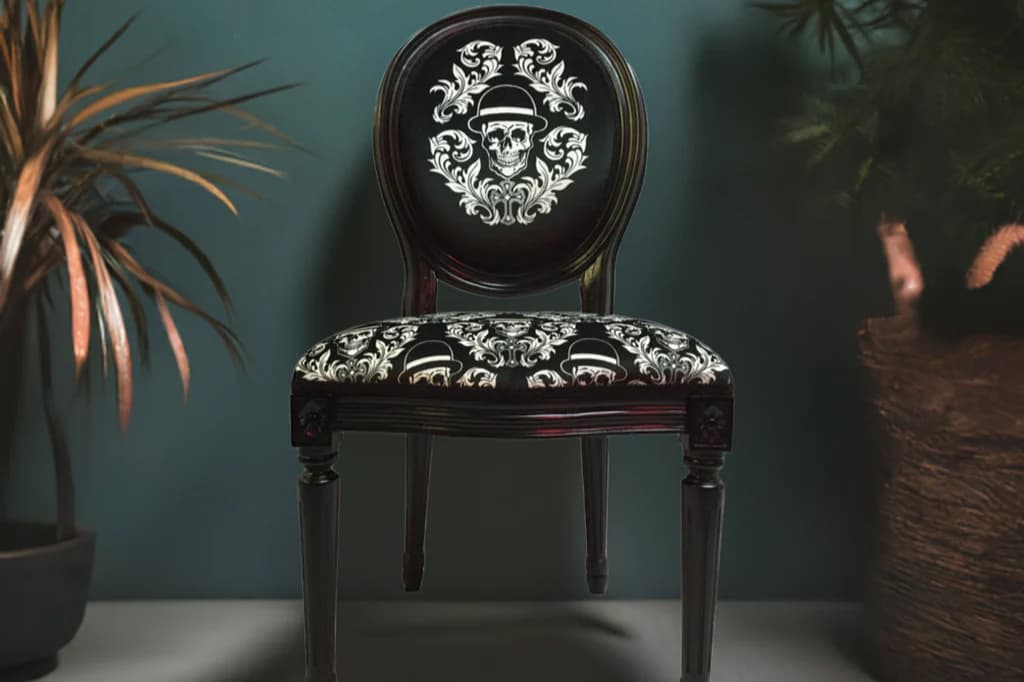 Statement black chair with intricate skull motif upholstery beside a yellow editorial panel promoting indie home décor from Brix + Bailey
