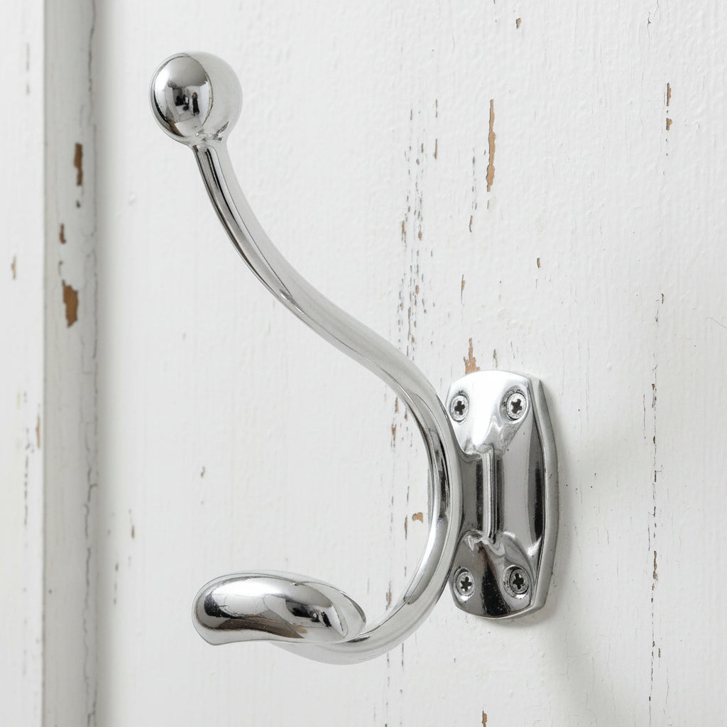 Minimalist chrome coat hanger with reflective silver finish for wall mounting, modern home organization by Sostter at brixbailey.com