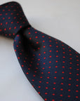 navy and red pin spot design tie