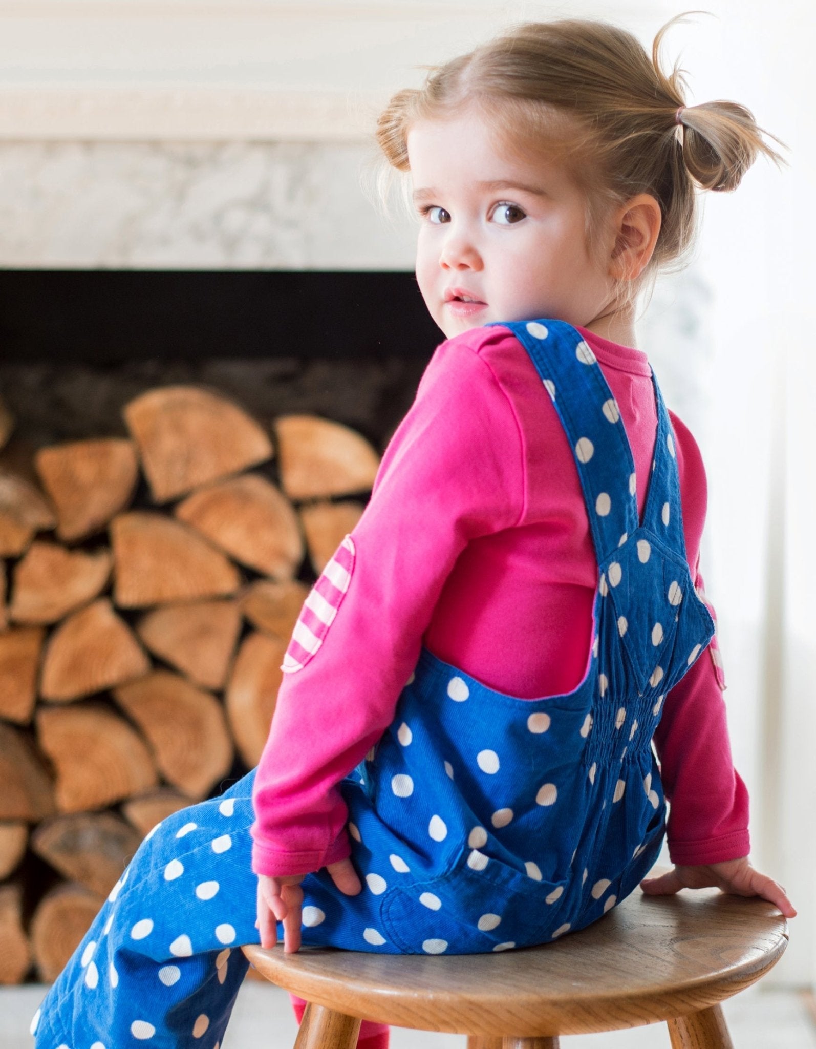 Premium organic cotton polka dot pinafore overall, soft blue with white dots and pink button accents, adjustable straps for growing kids by Toby Tiger at brixbailey.com