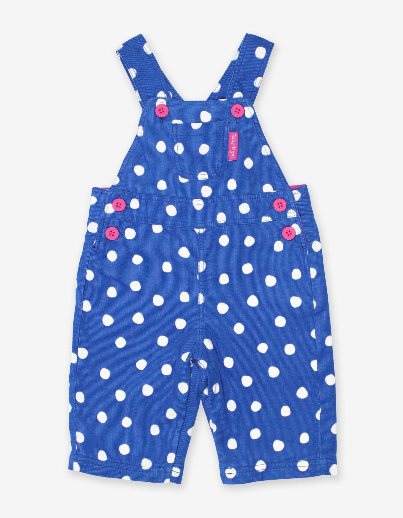 Premium organic cotton polka dot pinafore overalls, soft blue with white dots, stylish pink buttons, cozy jersey lining, adjustable straps by Toby Tiger at brixbailey.com