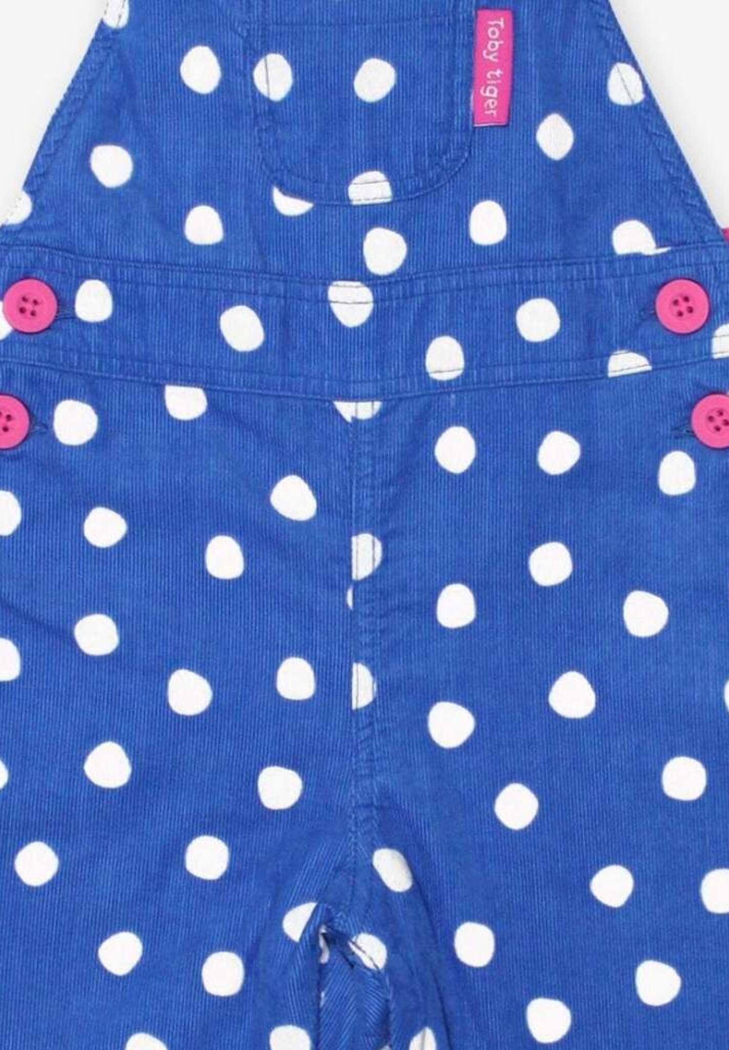 Premium organic cotton polka dot pinafore overall, soft blue with white dots, adjustable straps, snap buttons, cozy jersey lining by Toby Tiger at brixbailey.com