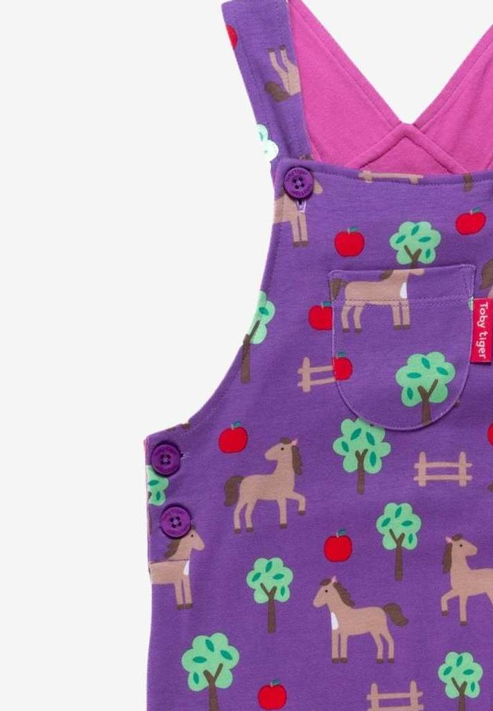 Premium organic cotton baby overalls with dreamy horse and apple print, adjustable straps, snap buttons, soft GOTS-certified jersey by Toby Tiger at brixbailey.com