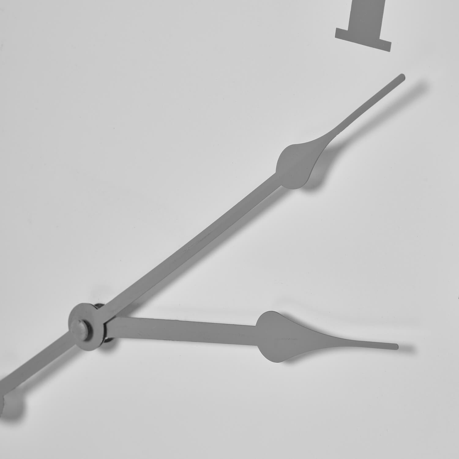 Modern white metal wall clock with clean circular design, 49cm, perfect for minimalist or industrial decor by Sostter at brixbailey.com