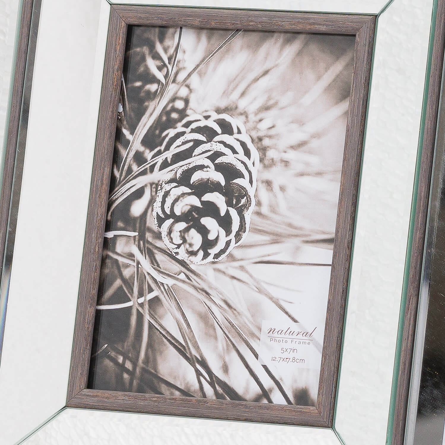 a soft-lit wood mirror frame with a warm brown finish, holding a 5x7 photo in its cozy embrace