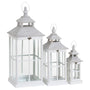 White wooden lantern with intricate window detailing, casting light patterns for coastal or Scandinavian decor. by RoomLondon at brixbailey.com