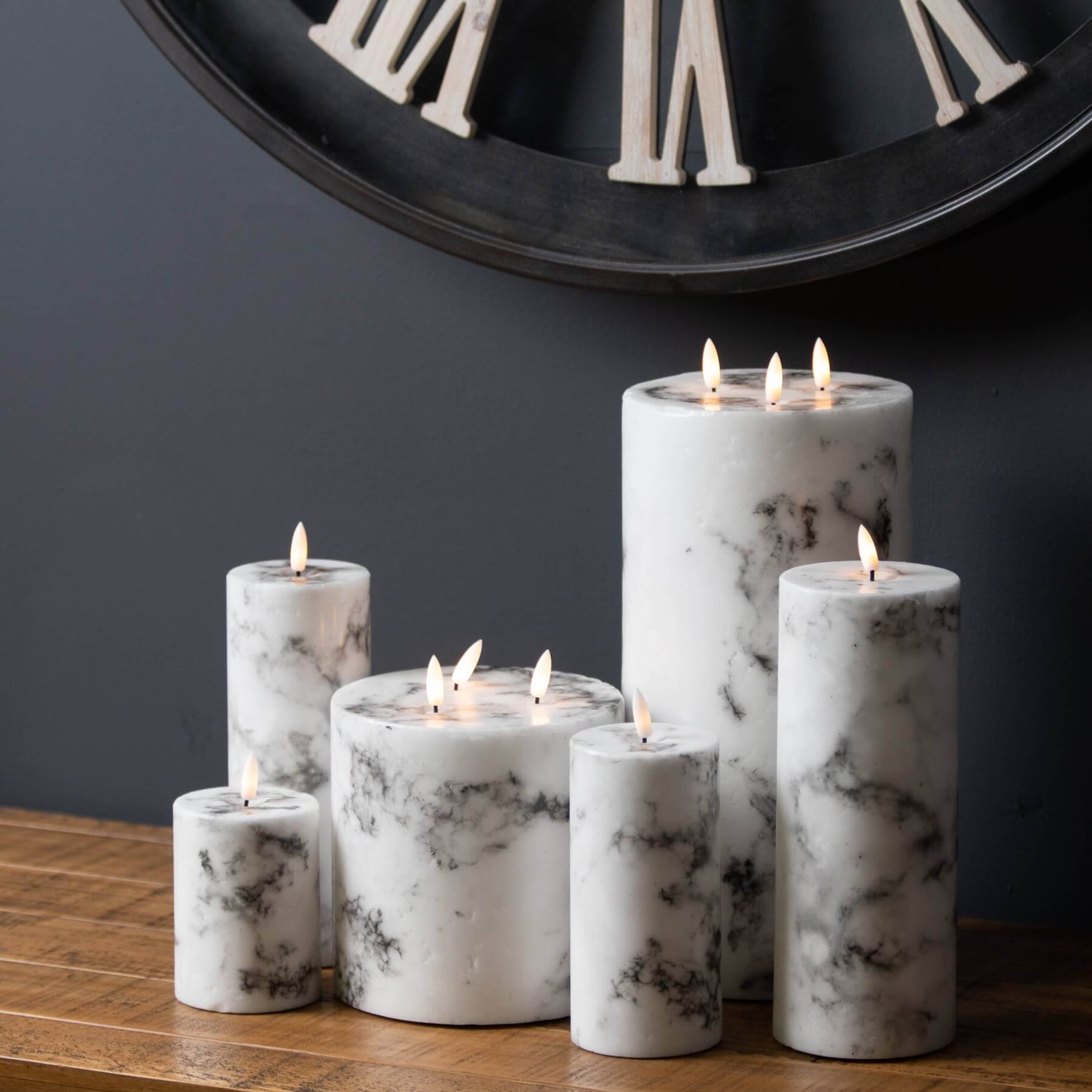 White marble-effect LED candle with amber flickering flame, safe plastic construction, elegant home decor accent. by Sostter at brixbailey.com