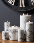 White marble-effect LED candle with amber flickering flame, safe plastic construction, elegant home decor accent. by Sostter at brixbailey.com