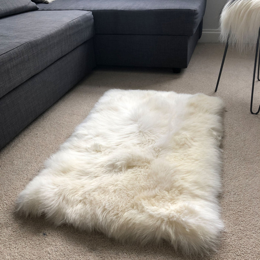 Premium British sheepskin rug, luxury white fur throw, soft plush ivory cream, handcrafted rectangular 55cm x 85cm, best-selling home decor by Wildash London at brixbailey.com